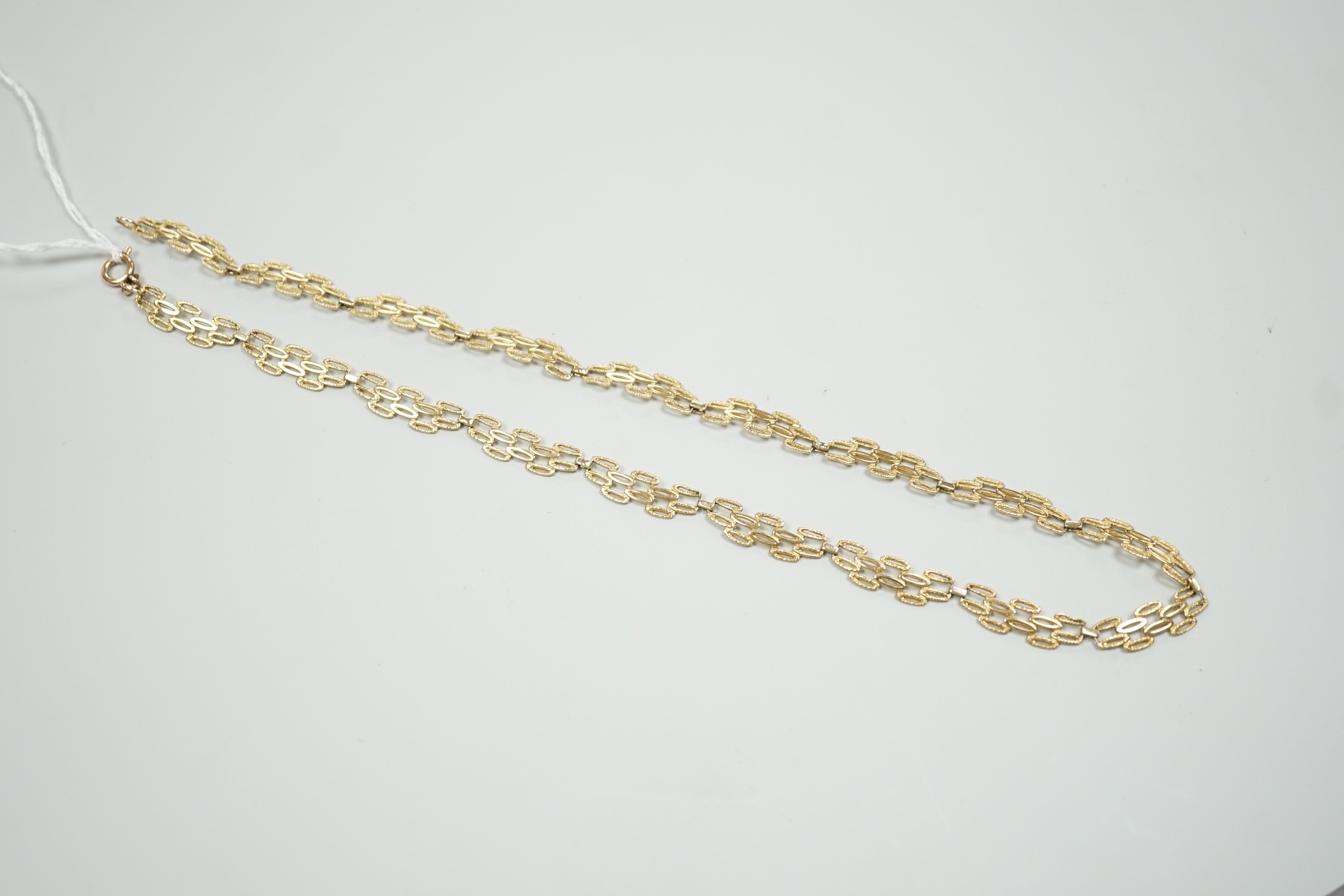 A 9ct gold pierced fancy link necklace, 45cm, 11 grams.